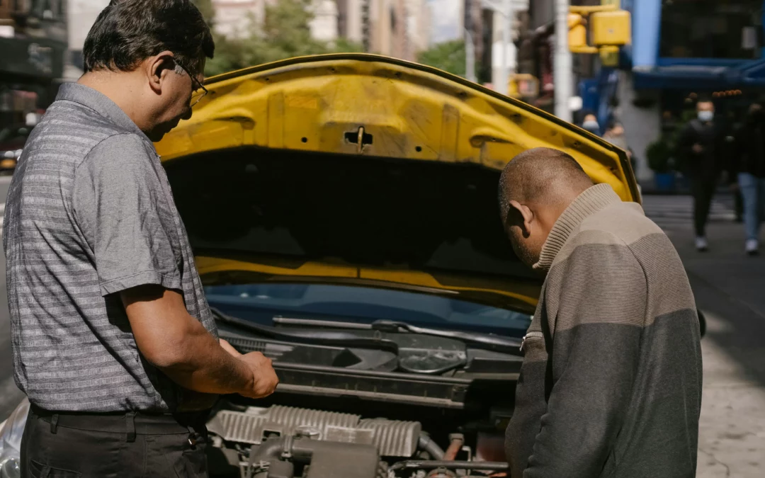 A customer and a mechanic looking at the Second-Hand Engine that was installed in a car.